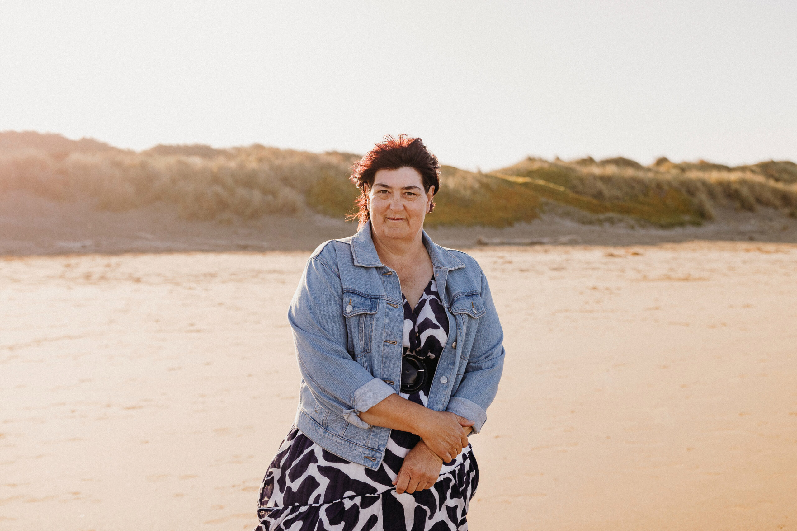 Catherine standing on the beach looking into the camera
